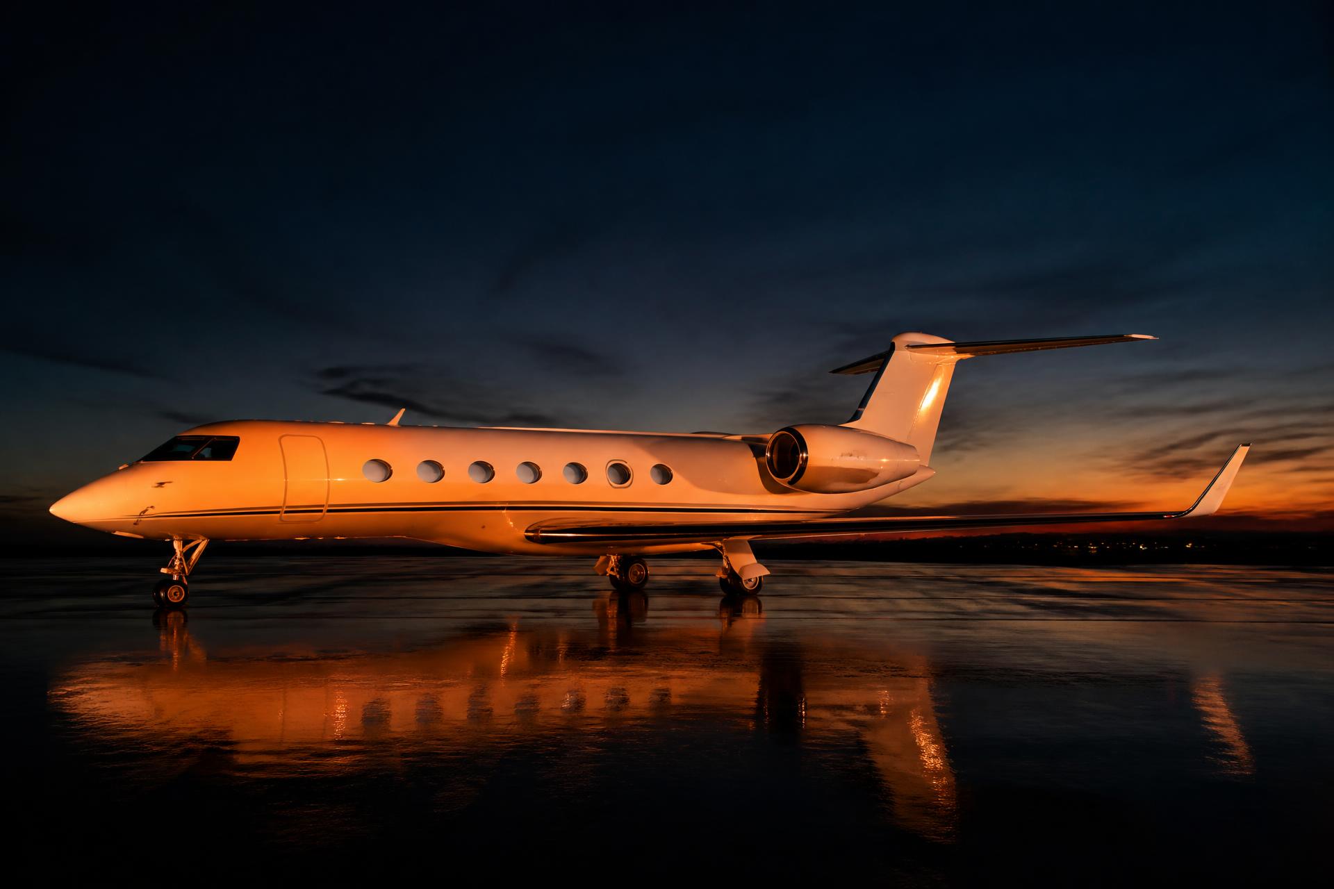 Private business jet on tarmac at twilight